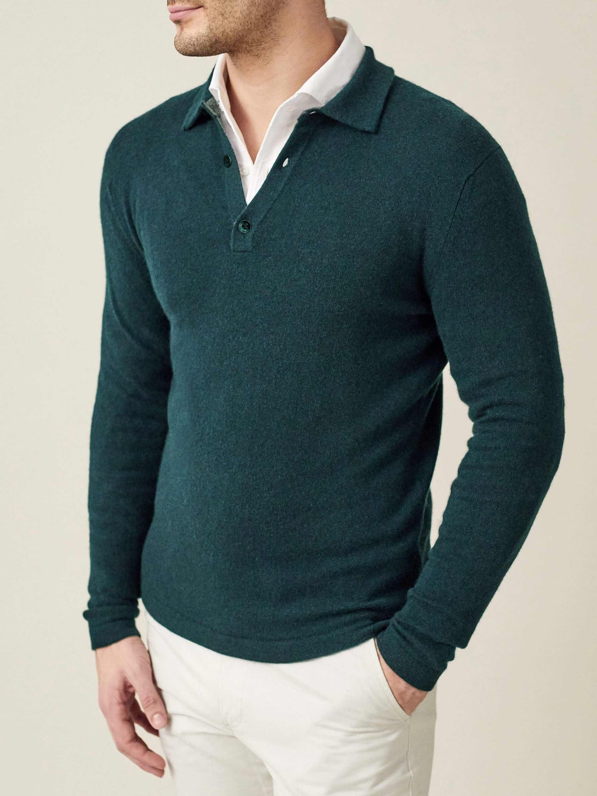 Front-side view of a man wearing the Luca Faloni forest green cashmere polo sweater layered over a white collared shirt.