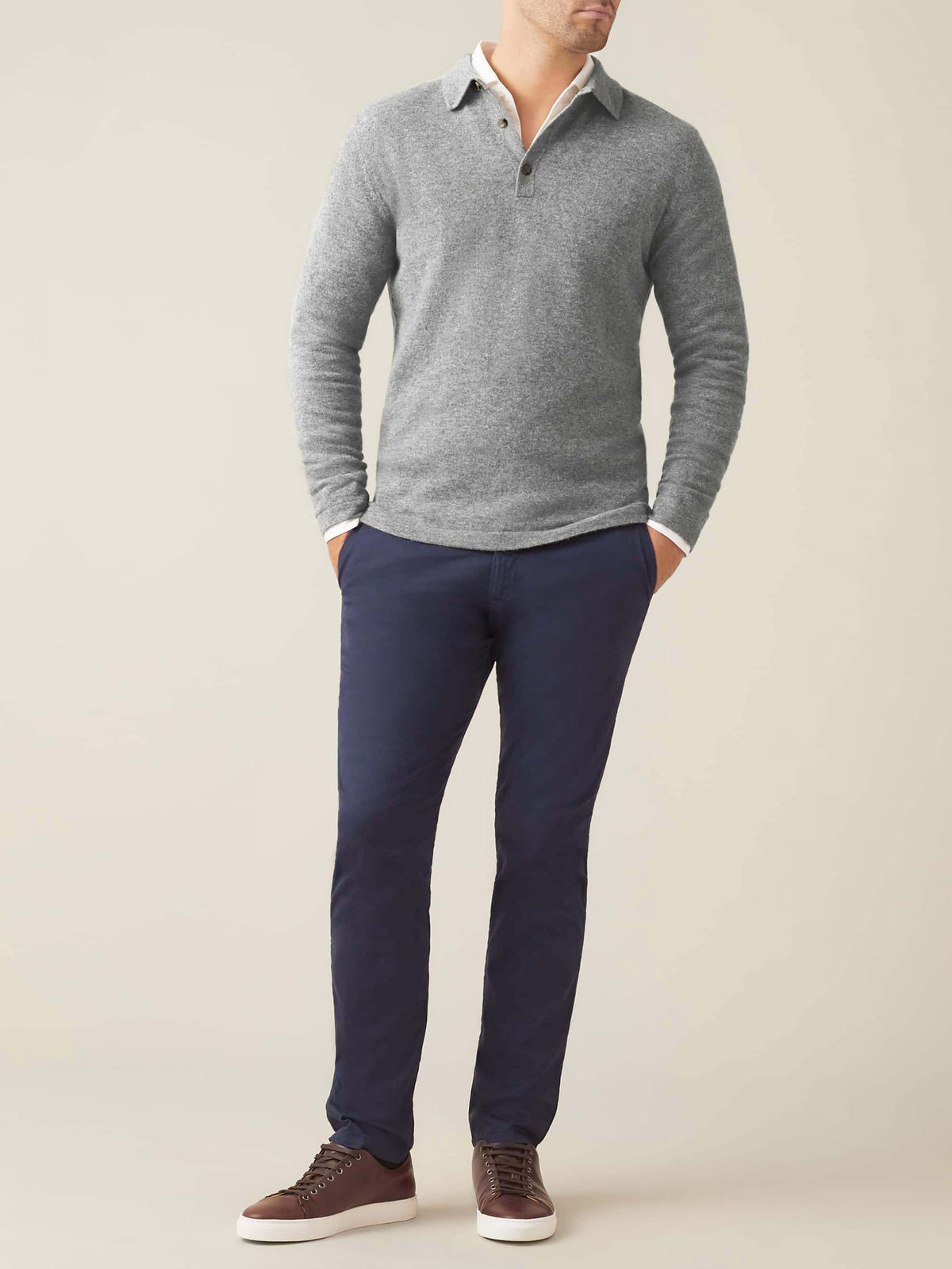 Front view of a model wearing Luca Faloni's Dolomiti Grey Cashmere Polo Sweater with navy chinos and brown sneakers.
