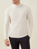 Front view of a man wearing the Luca Faloni Ivory Cashmere Roll Neck sweater styled with dark trousers.