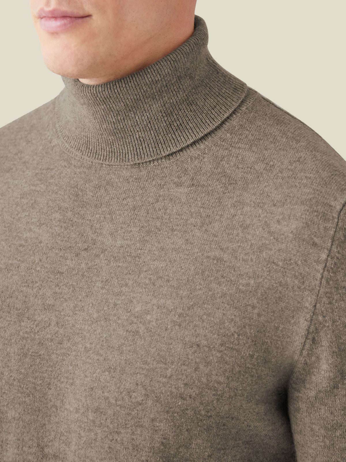 Detail shot of the Nocciola Brown Cashmere Roll Neck, highlighting the ribbed turtleneck and soft knit fabric.