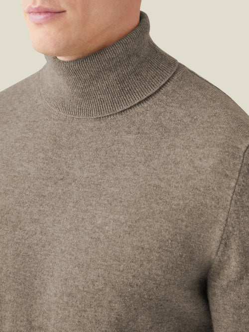 Detail shot of the Nocciola Brown Cashmere Roll Neck, highlighting the ribbed turtleneck and soft knit fabric.