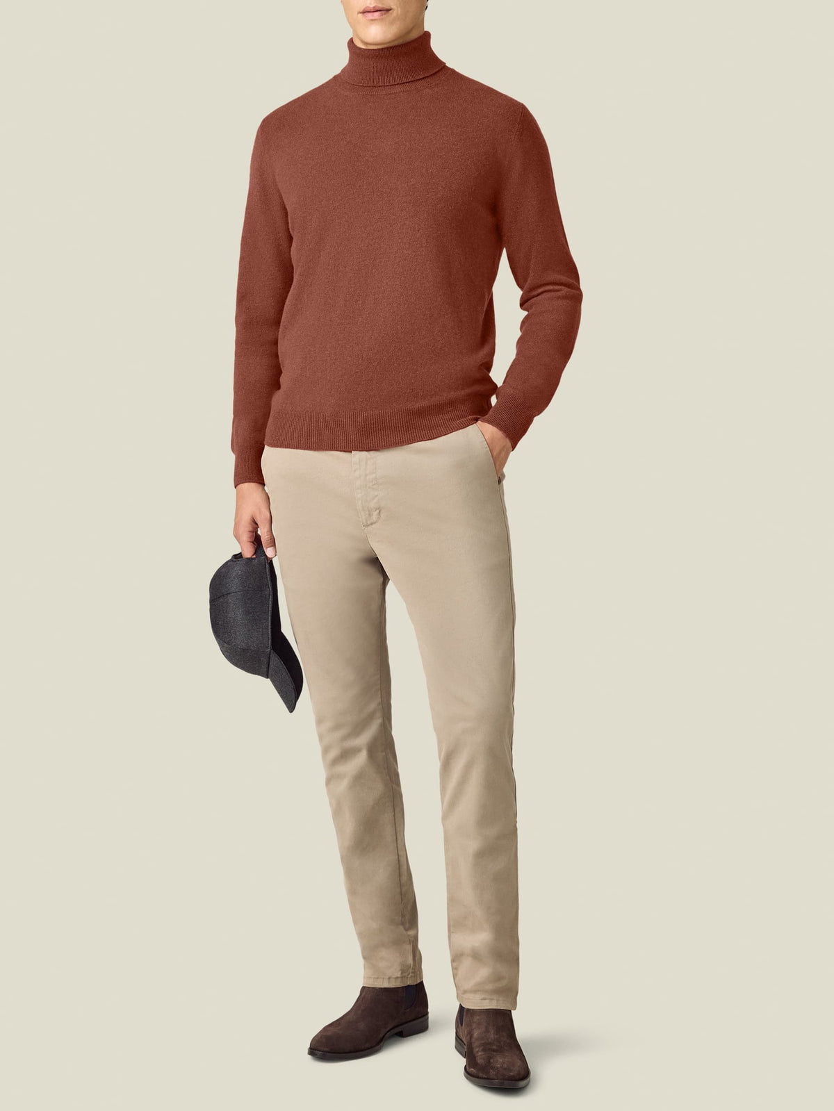 Front view of a model wearing the Luca Faloni Cashmere Roll Neck in rust with beige chinos and dark shoes.