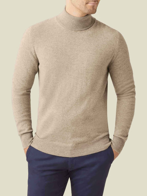 Front view of a man modelling the Luca Faloni Cashmere Roll Neck in Camel Beige.