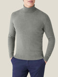 Front view of a model wearing the Luca Faloni Cashmere Roll Neck in Moss Green.