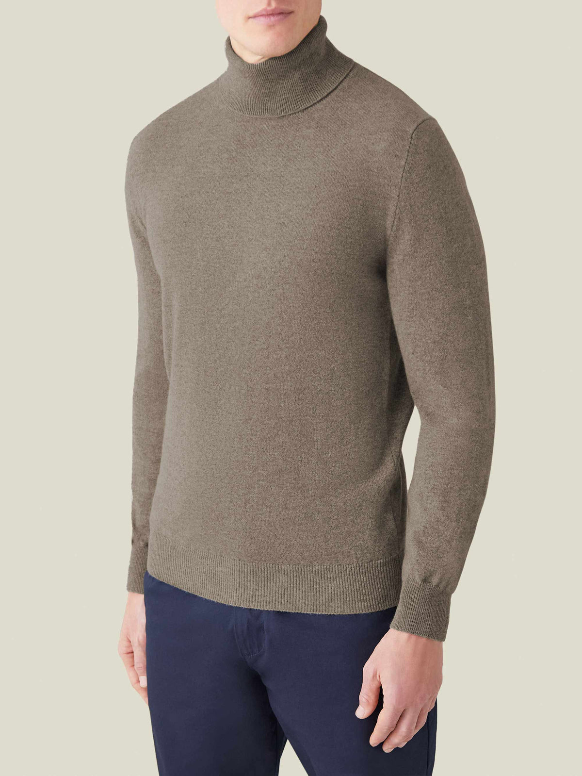 Front view of a model wearing the Luca Faloni Cashmere Roll Neck in Nocciola Brown.