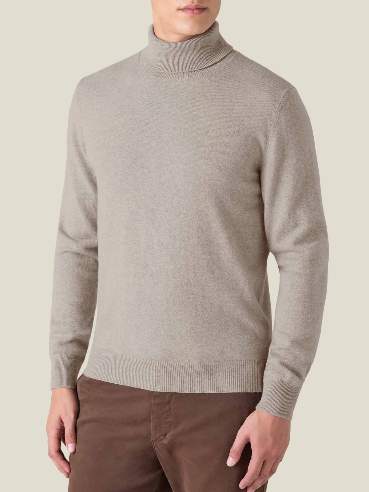 Front view of a model wearing the Luca Faloni Cashmere Roll Neck in almond against a plain background.