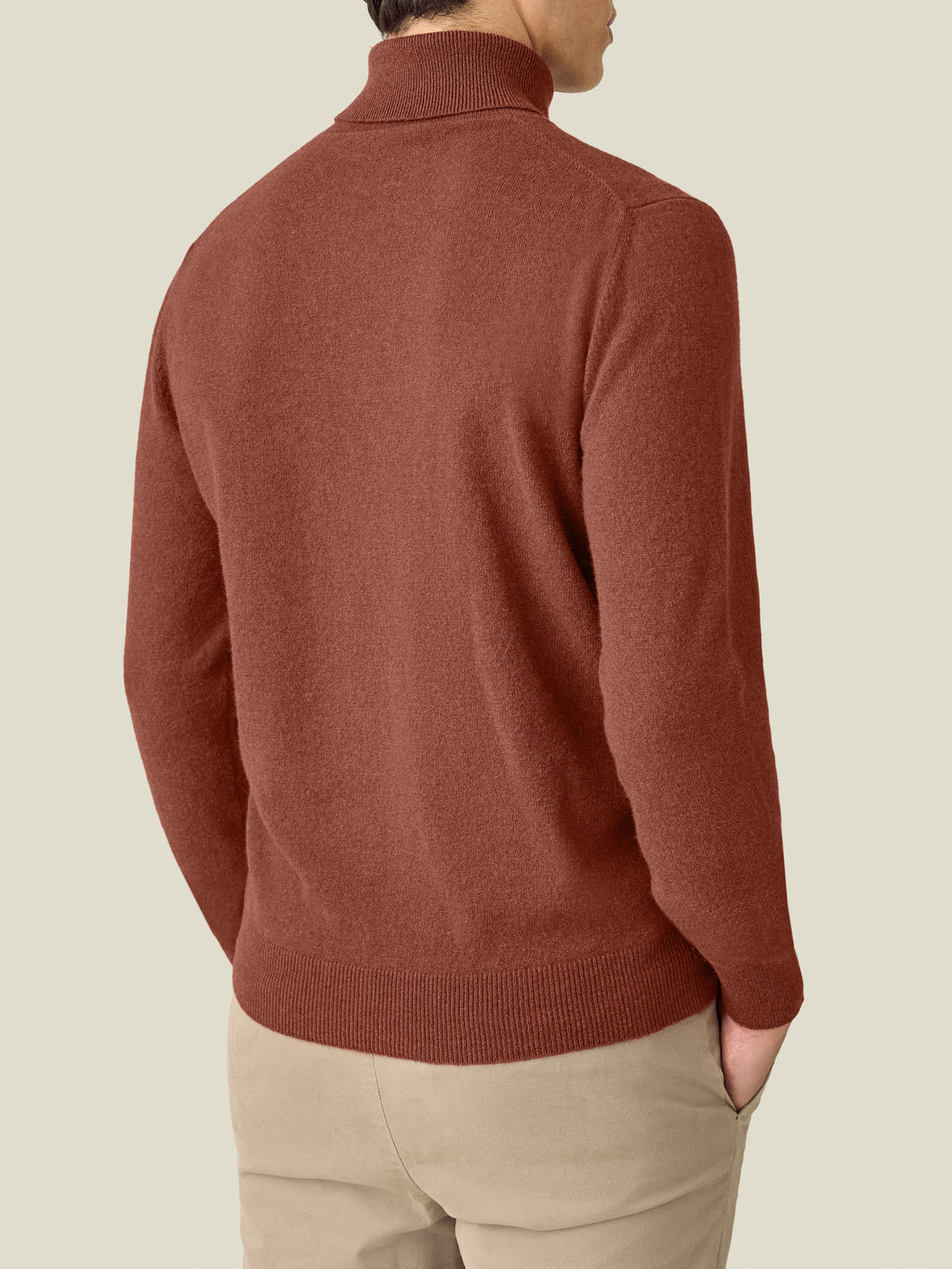 Back view of a model wearing the Luca Faloni Cashmere Roll Neck in rust.