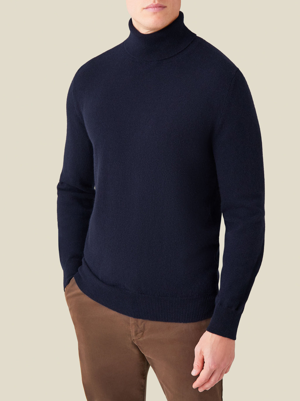 Front view of a model wearing the Luca Faloni Cashmere Roll Neck in midnight blue.