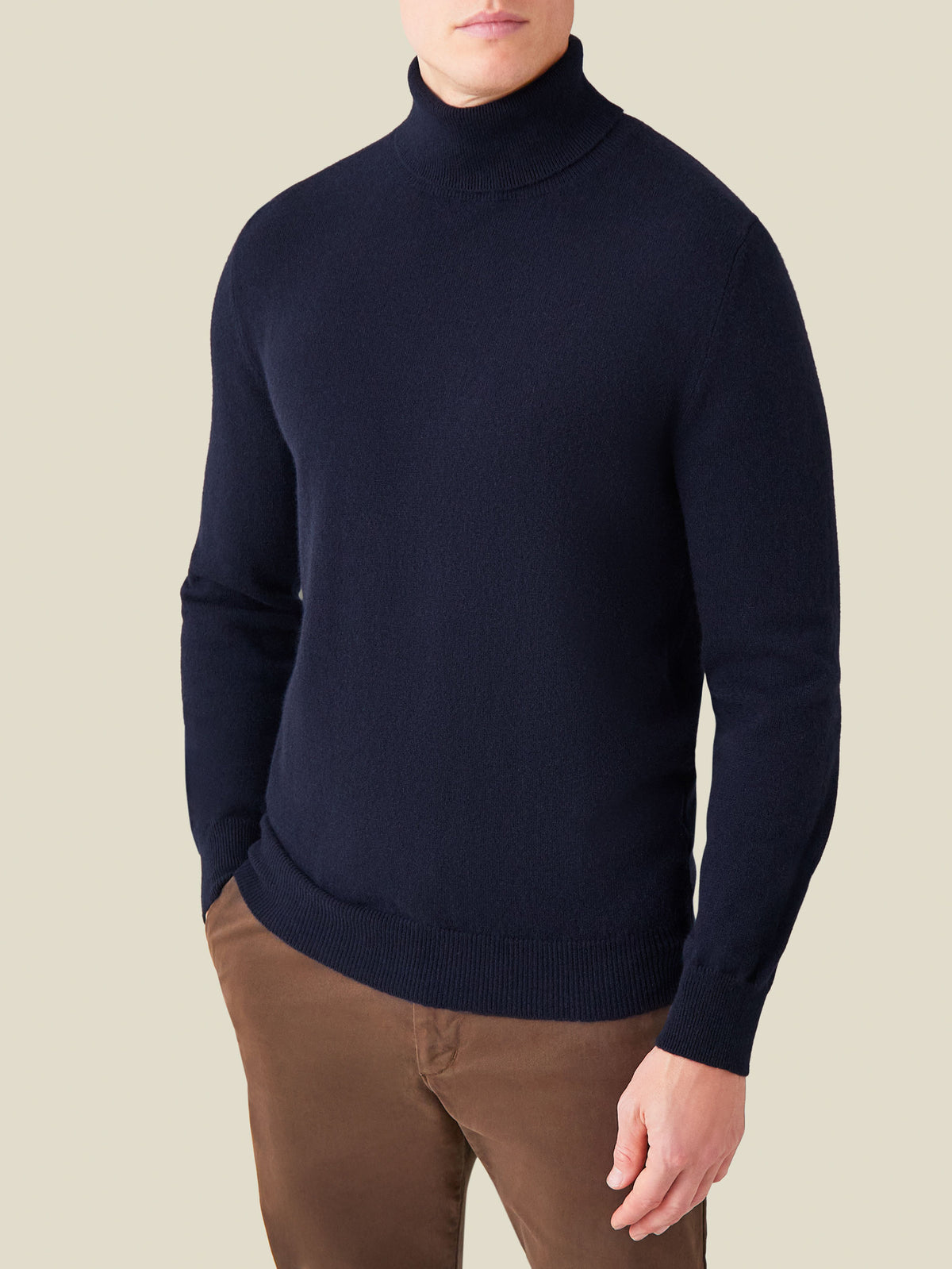 Front view of a model wearing the Luca Faloni Cashmere Roll Neck in midnight blue.