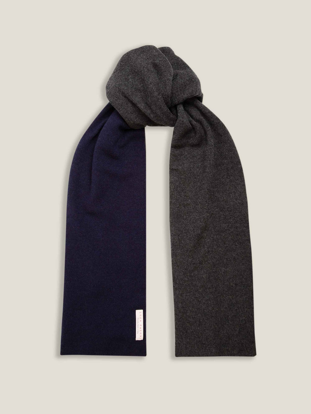 A studio shot of the Navy and Charcoal Double-Faced Cashmere Scarf, tied to display its reversible two-tone design.