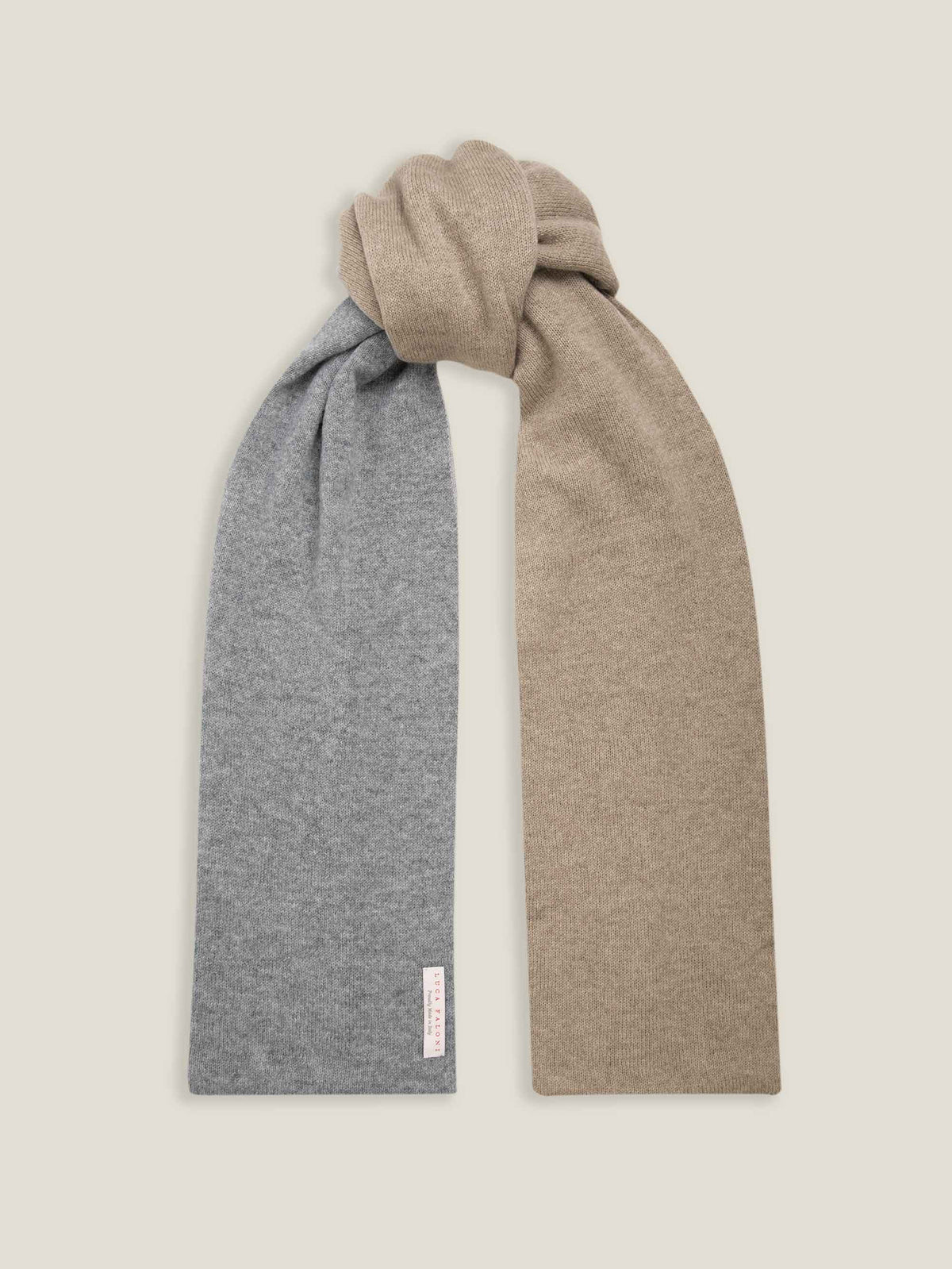 The Double-Faced Cashmere Scarf in camel and grey, shown tied in a knot to display both colours against a studio background.