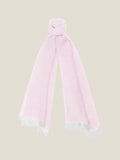 Luca Faloni's light pink linen scarf made in Italy, styled in a knot and showing the white fringed ends.