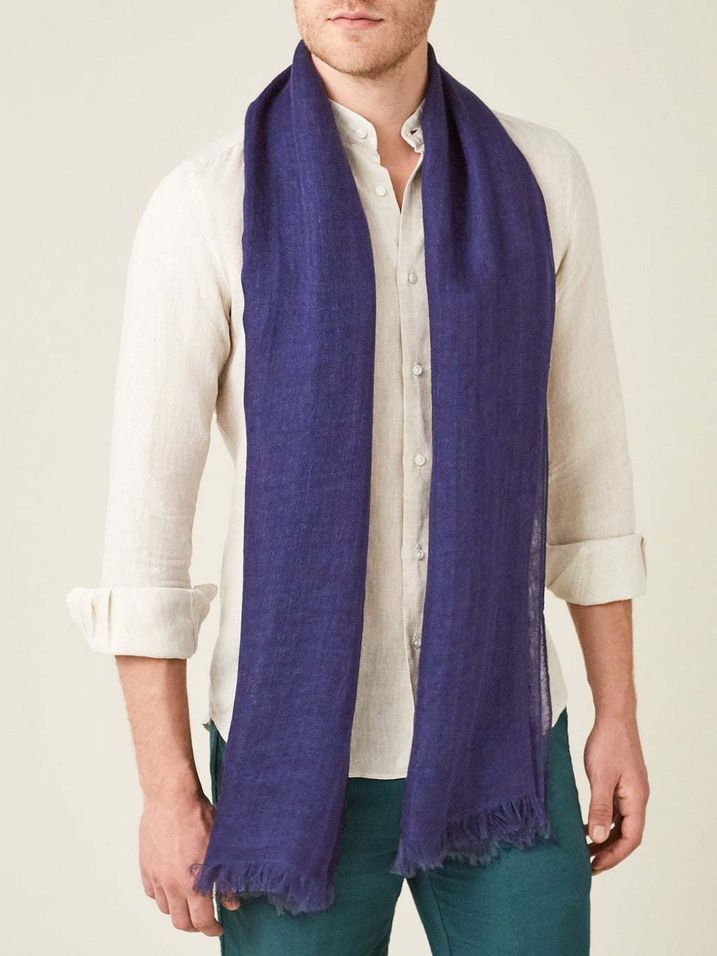 Front view of a model wearing the Luca Faloni Navy Blue Linen Scarf with an off-white linen shirt.