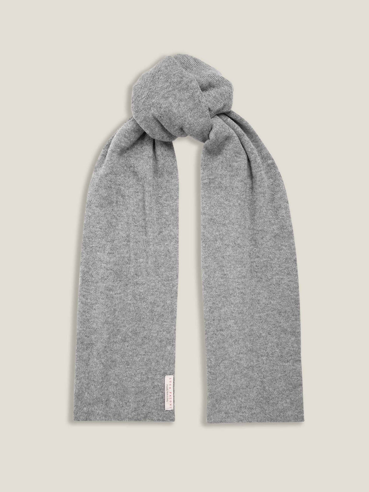 The Luca Faloni cashmere scarf in Dolomiti Grey, presented in a simple knot against a neutral background.