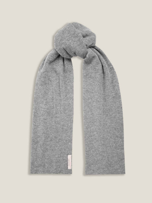 The Luca Faloni cashmere scarf in Dolomiti Grey, presented in a simple knot against a neutral background.
