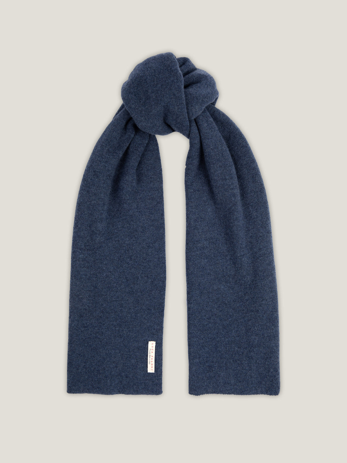 The Luca Faloni Cashmere Scarf in Atlantic Blue, tied in a soft knot and displayed against a neutral background.