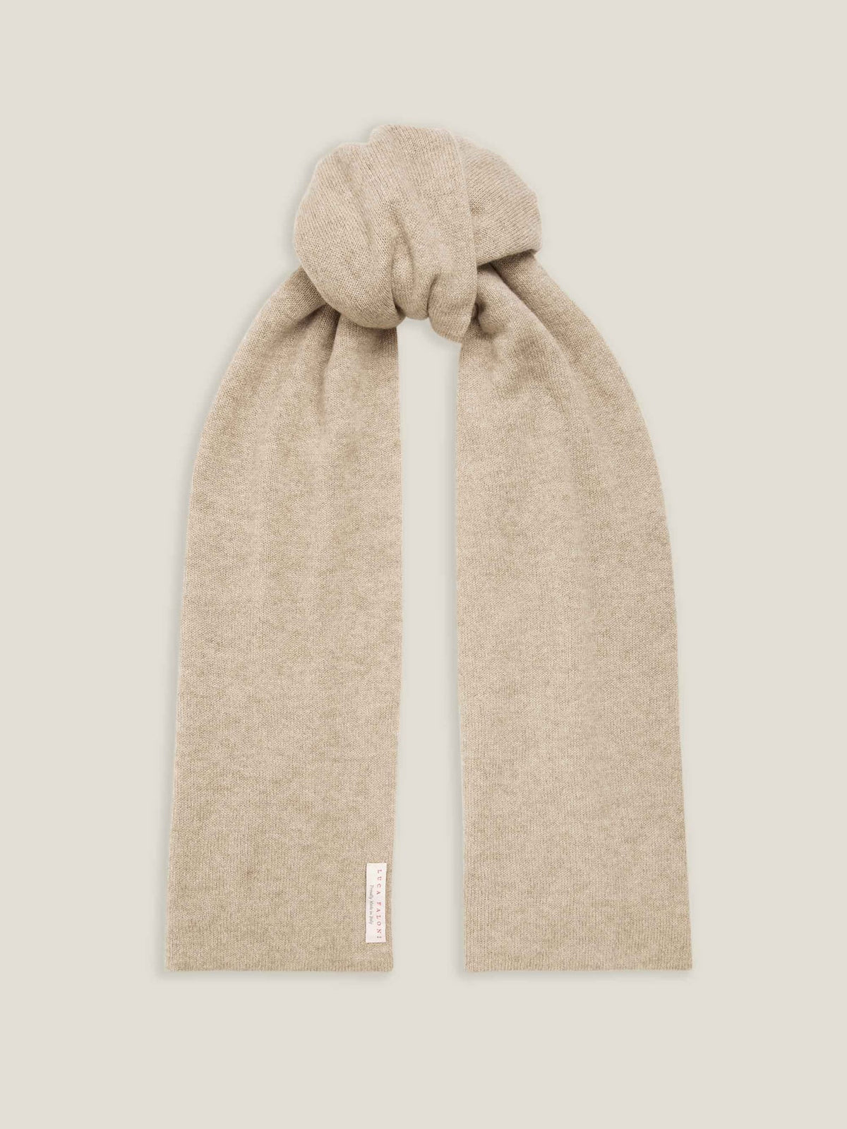 A Luca Faloni classic cashmere scarf in camel beige, shown knotted against a neutral studio background.