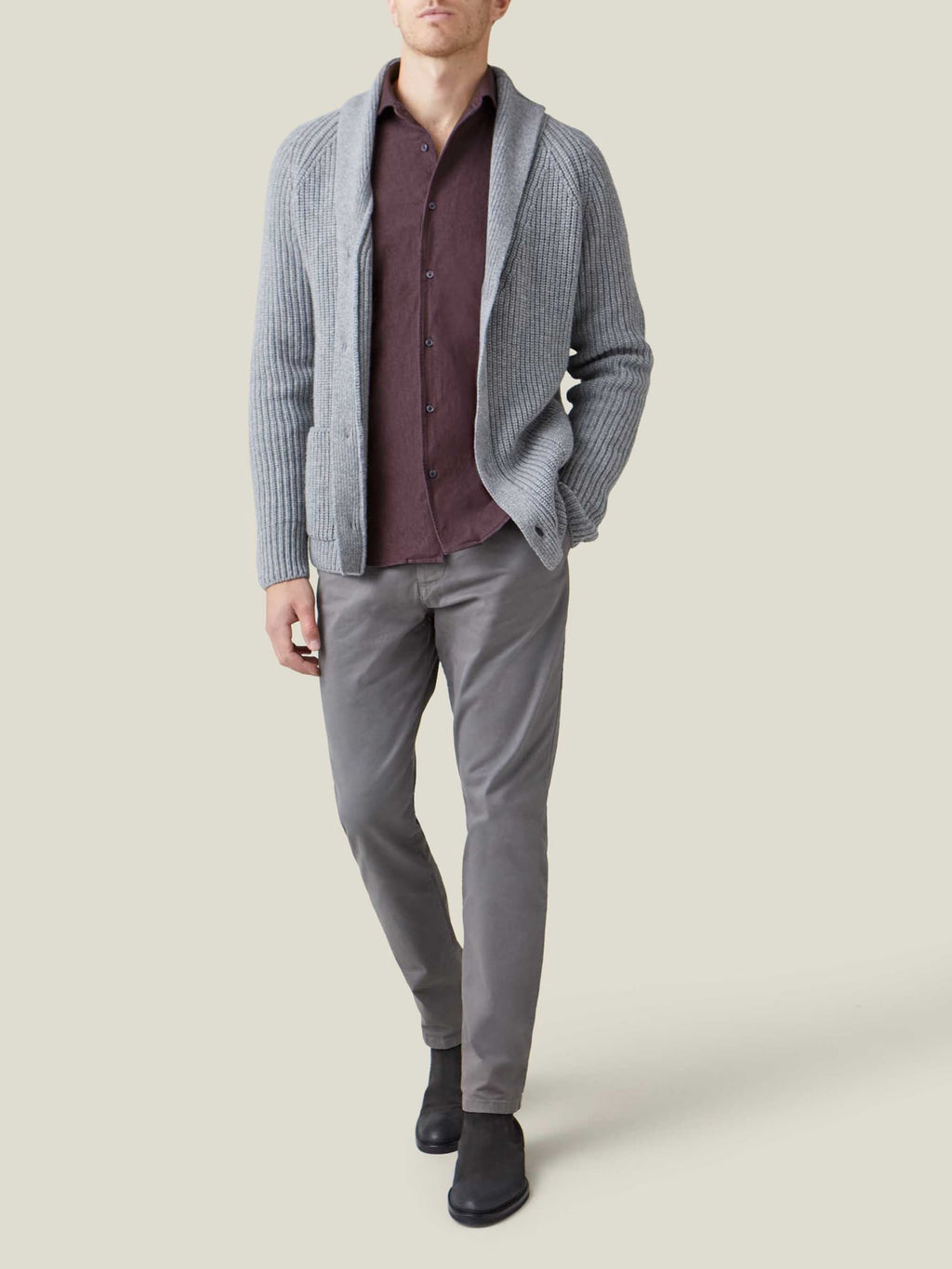 A model wears the Luca Faloni Burgundy Denim Shirt under a grey cardigan, paired with grey trousers and black boots.