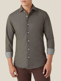 A model presents the regular fit Luca Faloni Denim Shirt in Military Green, styled with rolled-up sleeves.
