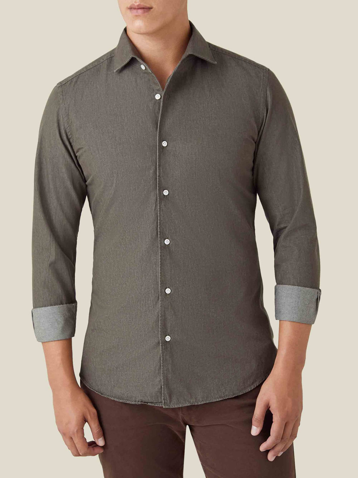A model presents the regular fit Luca Faloni Denim Shirt in Military Green, styled with rolled-up sleeves.