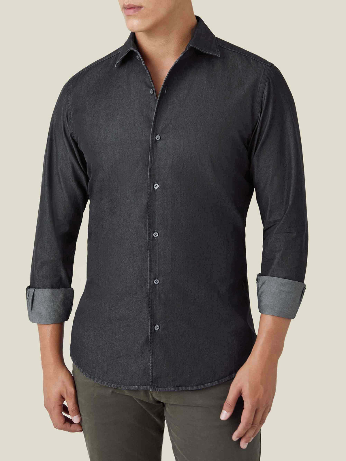 Front view of a model wearing Luca Faloni's Black Denim Shirt with the sleeves rolled up.