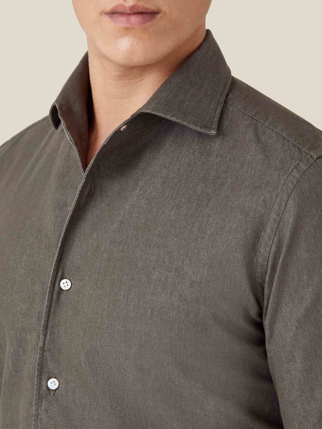 Close-up of a man wearing the Luca Faloni Military Green Denim Shirt, showing the one-piece collar and fabric texture.
