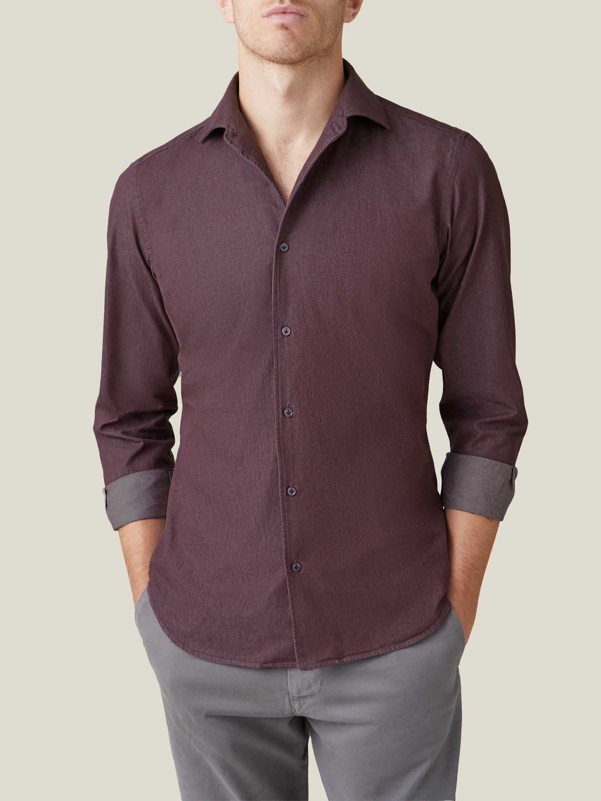 Model seen from the front wearing the Luca Faloni Burgundy Denim Shirt with rolled-up sleeves and styled with grey trousers.