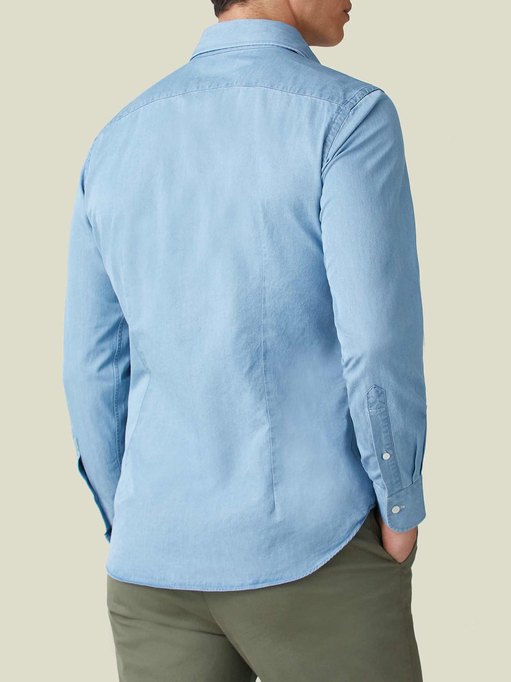 Back view of a man wearing the Luca Faloni light blue Denim Shirt with olive trousers.