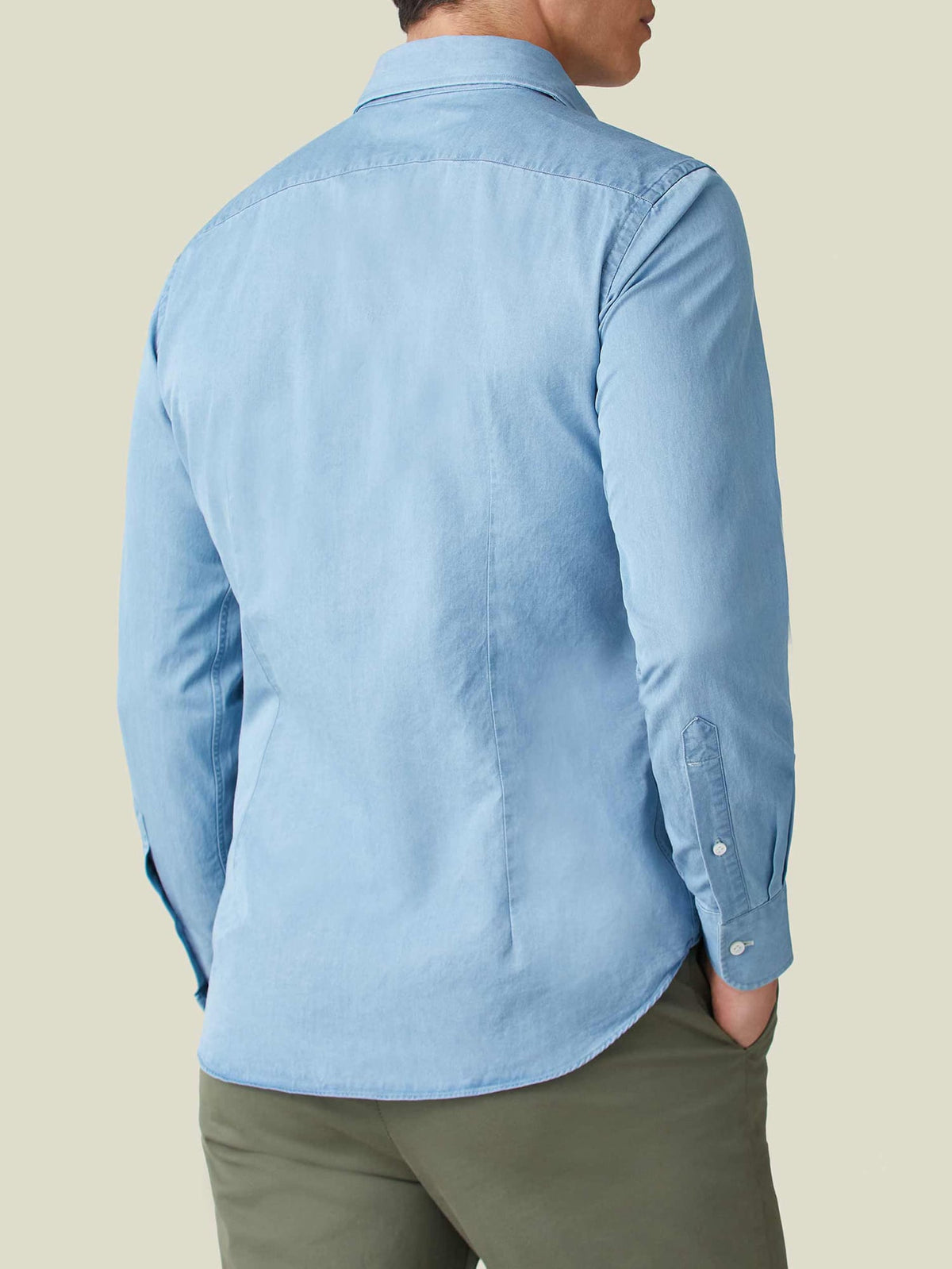 Back view of a man wearing the Luca Faloni light blue Denim Shirt with olive trousers.