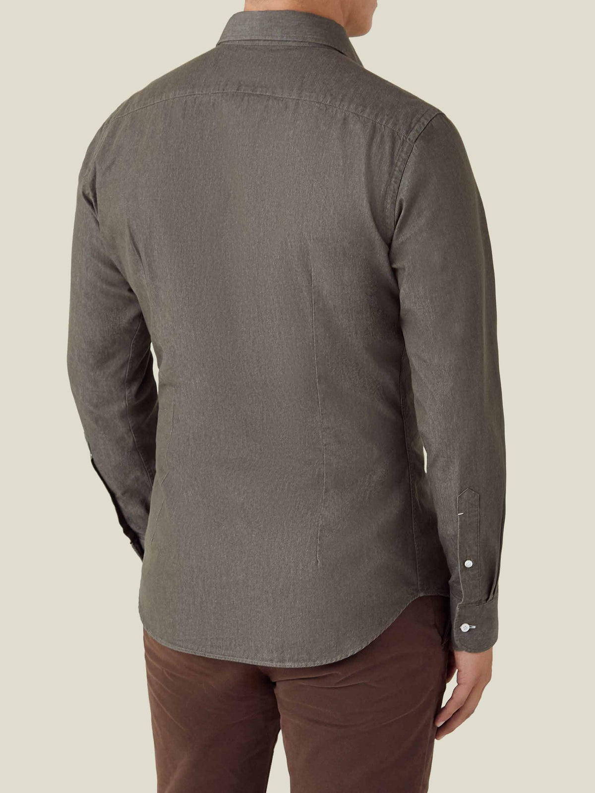 Rear view of a man wearing the Luca Faloni Denim Shirt in military green, highlighting its slim fit and curved hem.