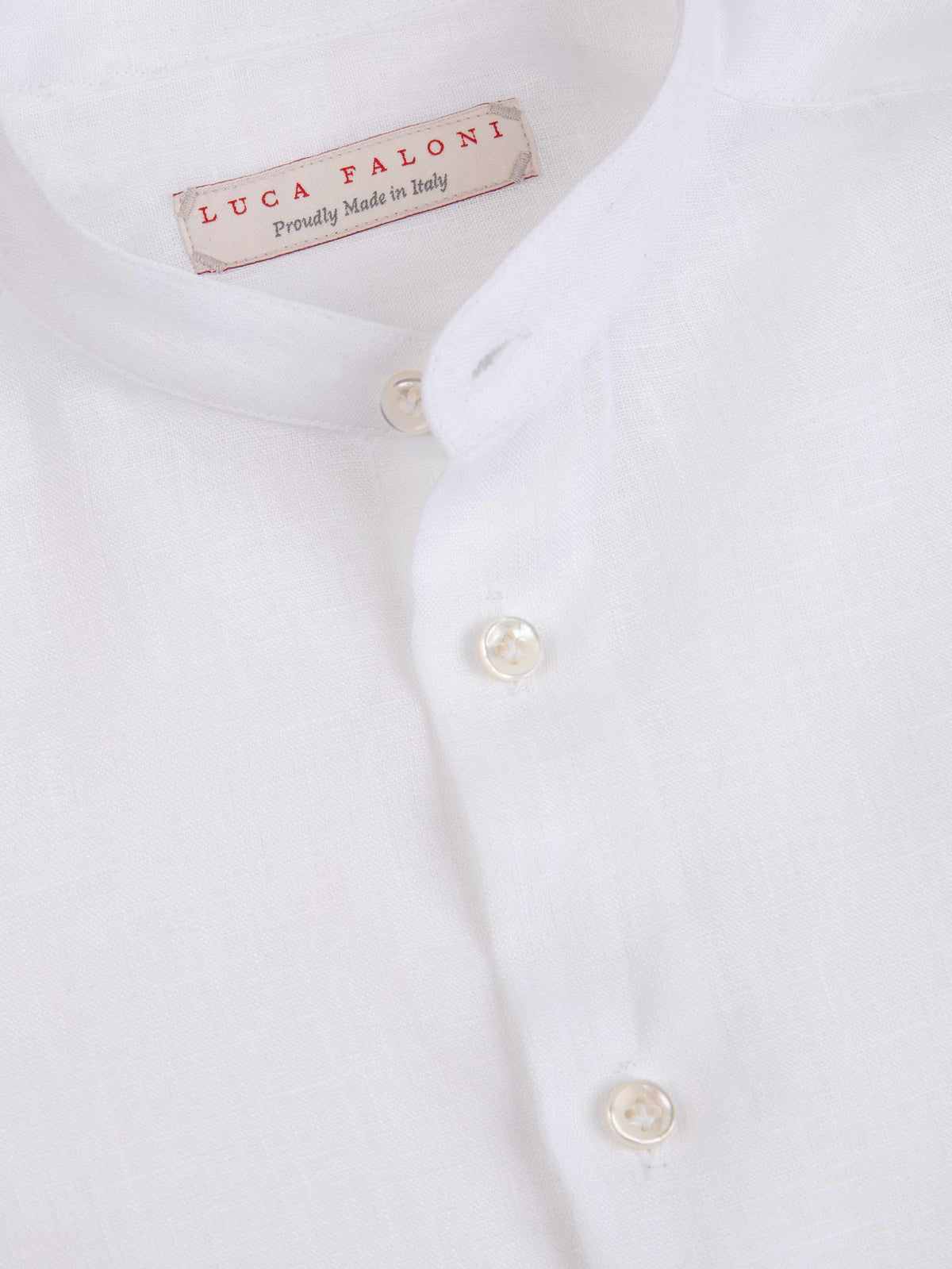 Close-up of the Luca Faloni label, band collar and mother-of-pearl buttons on the white Forte Junior Linen Shirt.