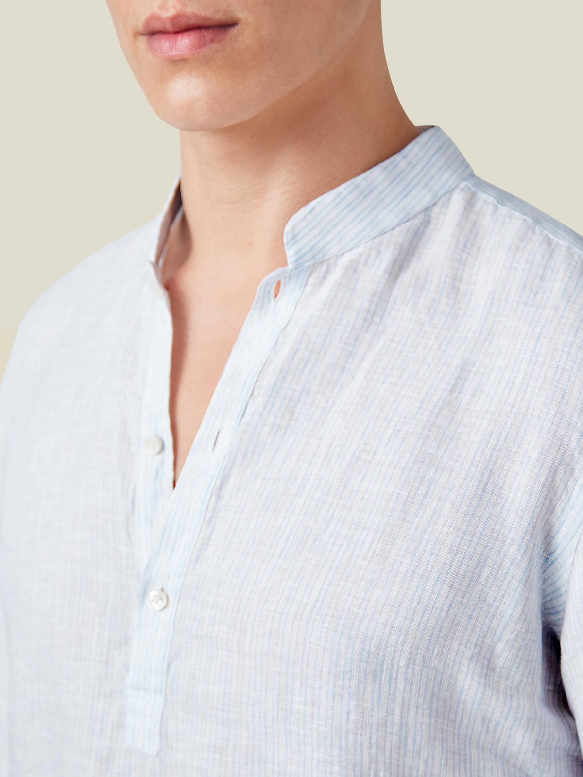 Close-up of the band collar and placket of the Luca Faloni Forte Linen Shirt in a light blue and white thin stripe.