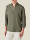 Front view of a model wearing the Forte Linen Shirt in Khaki Green, showcasing its band collar and rolled-up sleeves.