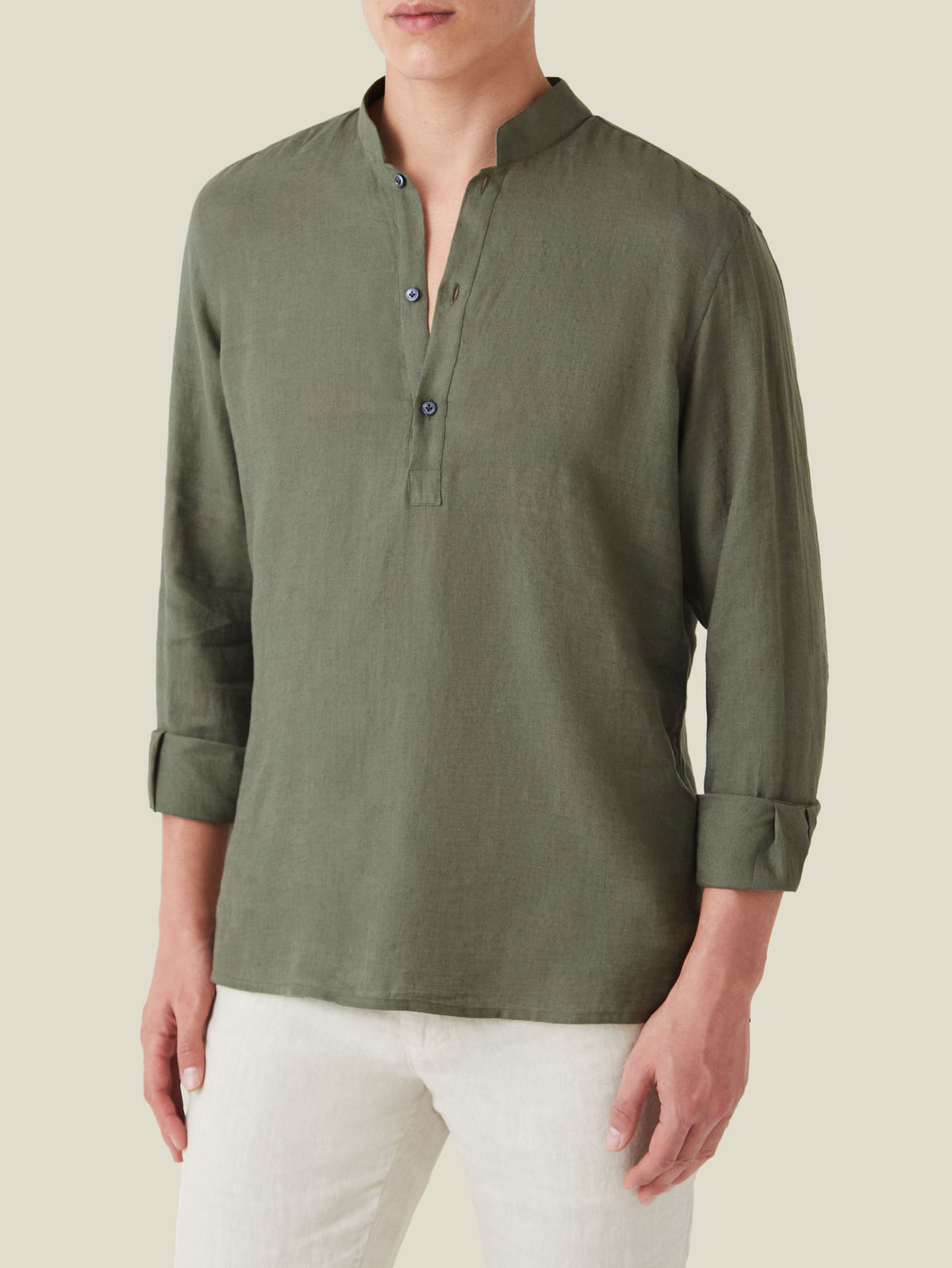 Front view of a model wearing the Forte Linen Shirt in Khaki Green, showcasing its band collar and rolled-up sleeves.