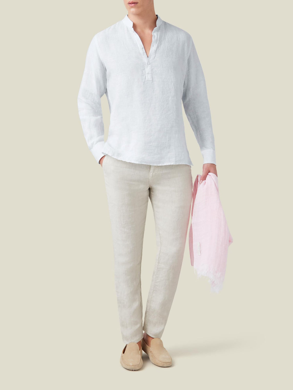 Full outfit view of a model wearing the thin striped Forte Linen Shirt with beige linen trousers and suede loafers.