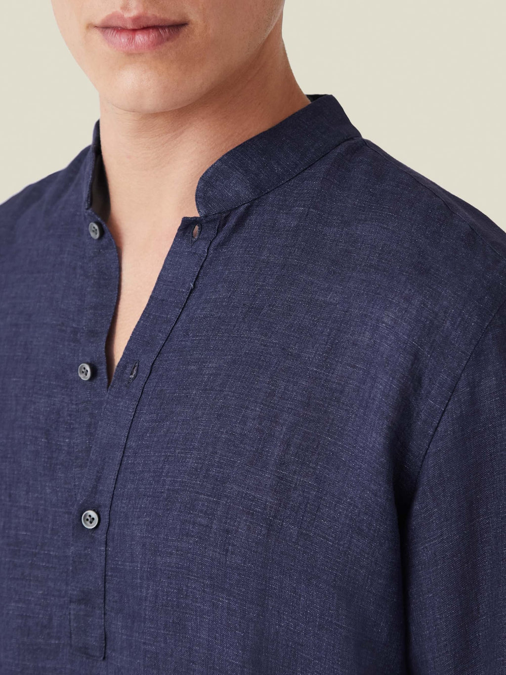 Close-up of the navy blue Forte Linen Shirt, highlighting its band collar and pure linen texture.