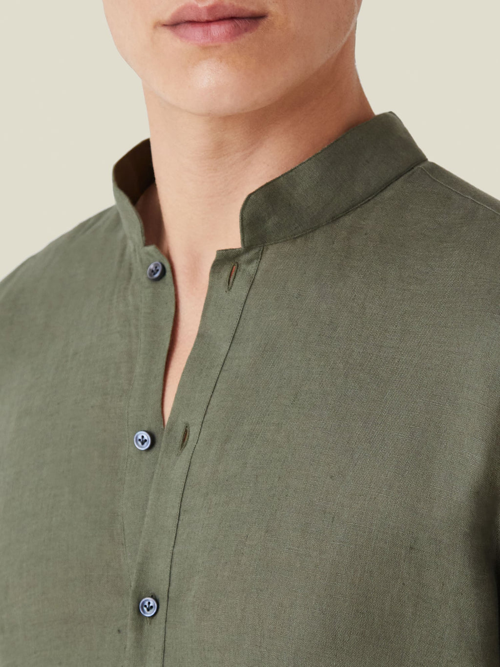 A close-up of the Khaki Green Forte Linen Shirt, showcasing the band collar and mother of pearl buttons.