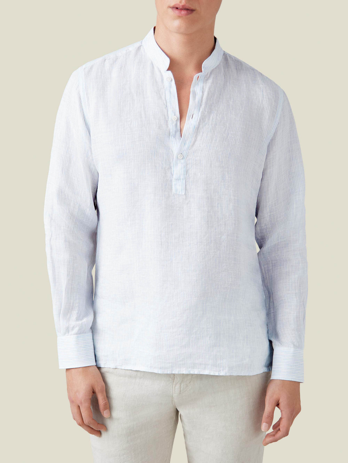 Front view of a model wearing the Forte Linen Shirt in a light blue thin striped pattern, featuring a band collar.