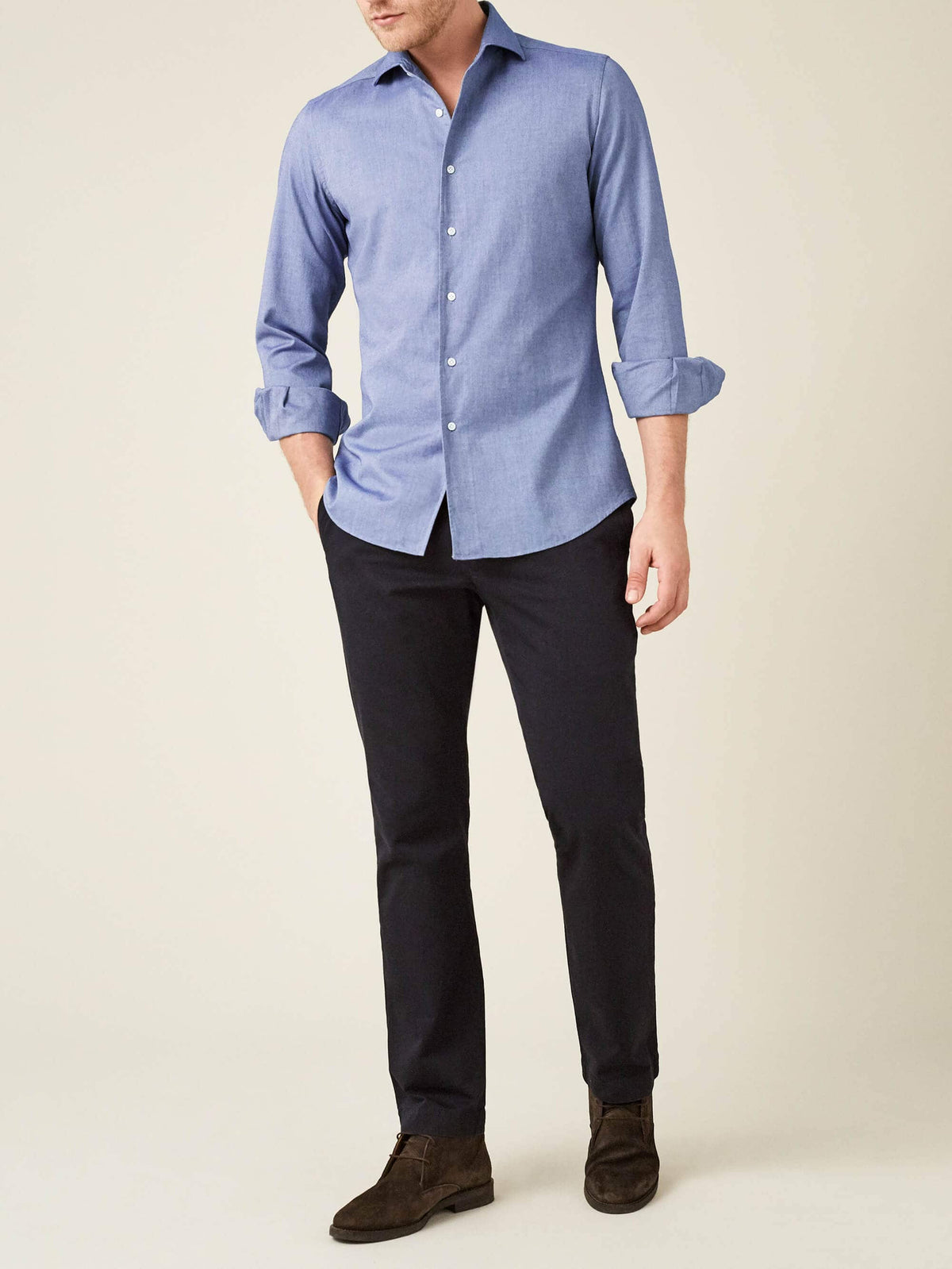 Full outfit view of a model wearing the indigo Brushed Cotton Shirt by Luca Faloni with dark trousers and suede boots.