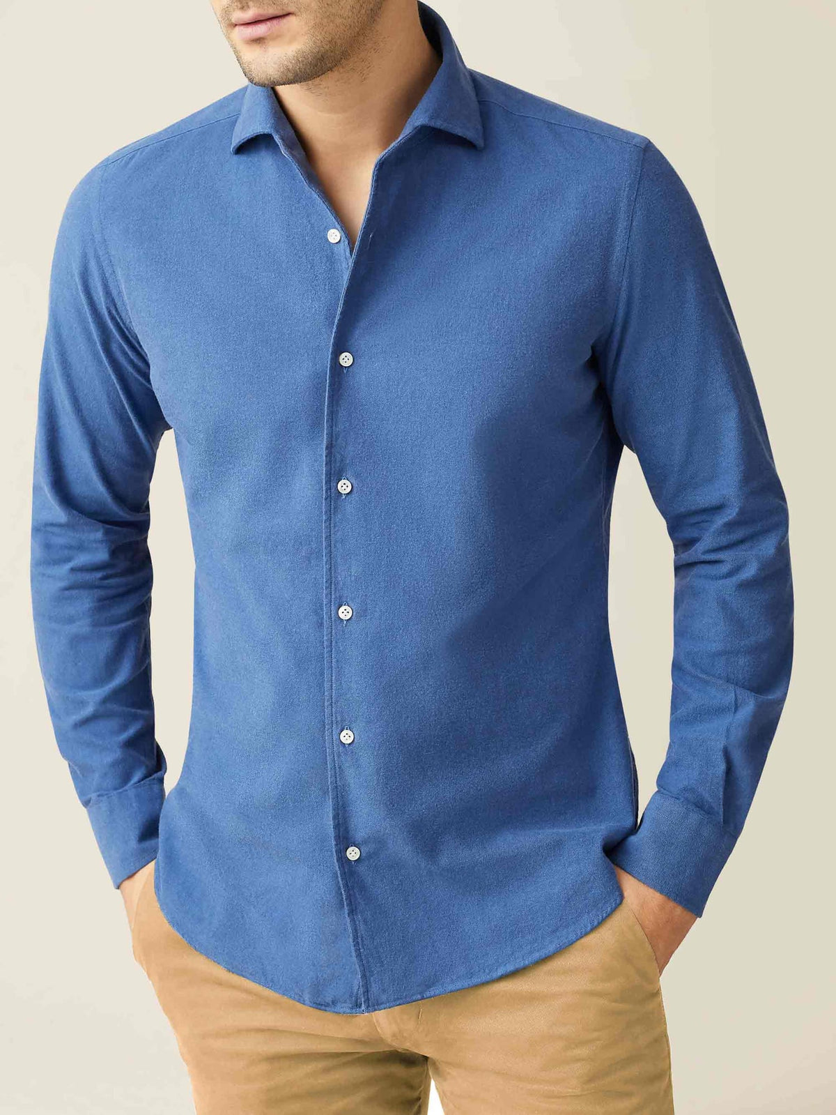 Model wearing the Luca Faloni Brushed Cotton Shirt in Chambray Blue, styled with light brown chinos.