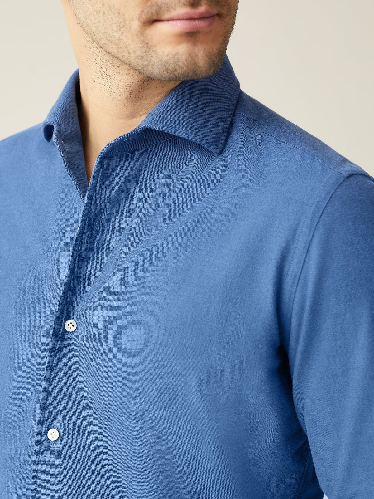 A detailed close-up of a man wearing the Chambray Blue Brushed Cotton Shirt, showing the soft texture and one-piece collar.