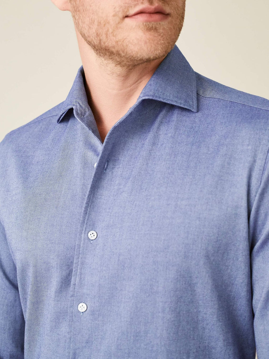 Close-up of a man wearing the indigo Brushed Cotton Shirt, showing the soft fabric texture and one-piece collar.