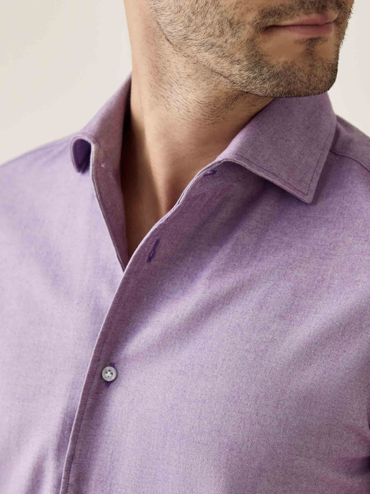 Close-up of a model wearing Luca Faloni's purple Brushed Cotton Shirt, showing the soft fabric and one-piece collar.