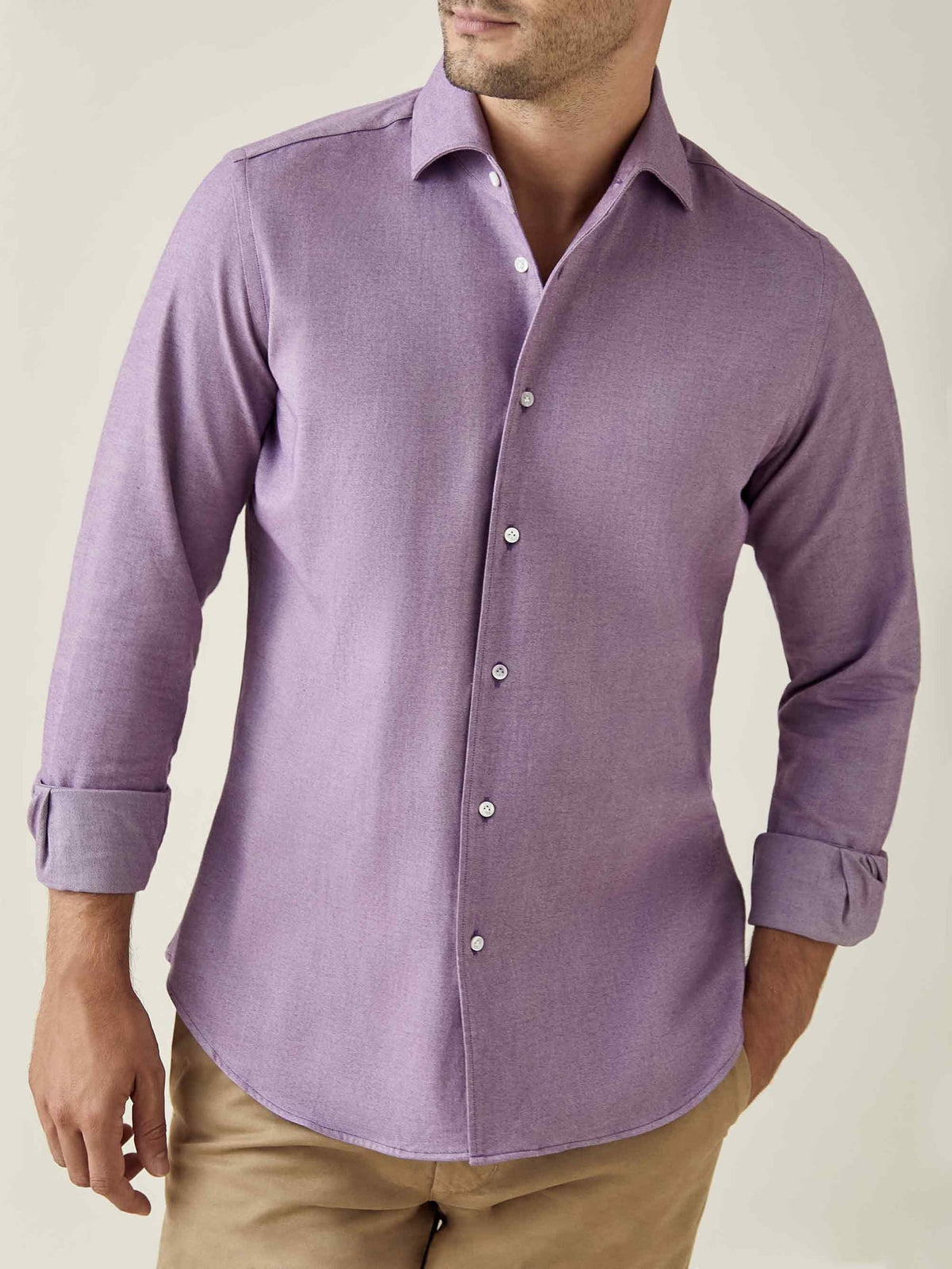 A model wears the purple Brushed Cotton Shirt with rolled-up sleeves and beige chinos.