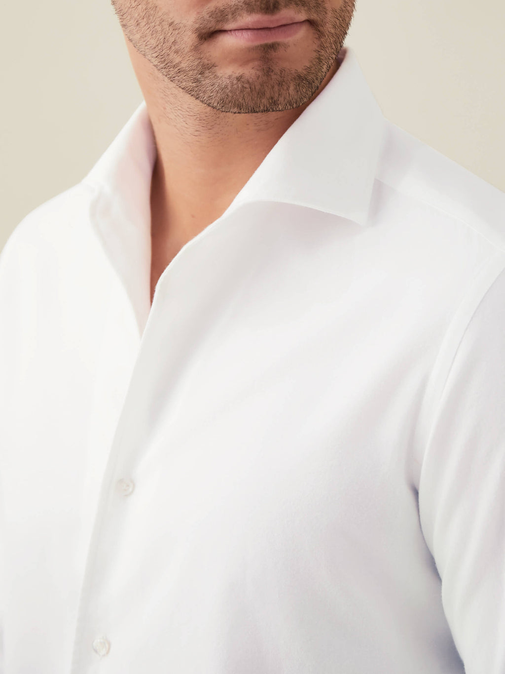 Close-up of a model wearing the Luca Faloni white brushed cotton shirt, showing detail of the one-piece collar.