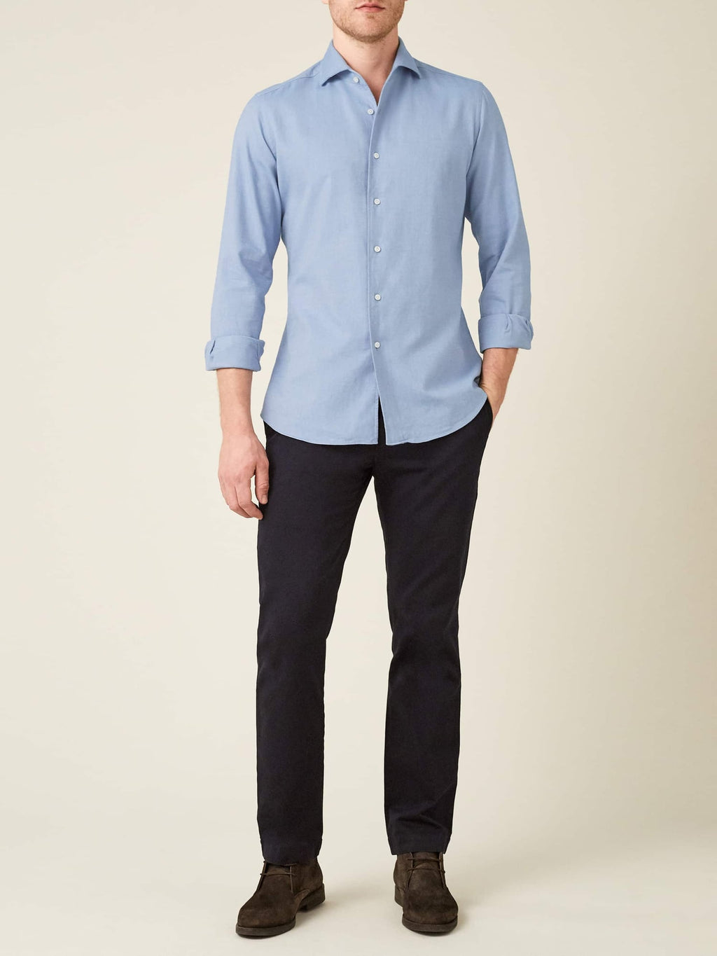 Front view of a model wearing the Luca Faloni light blue brushed cotton shirt, paired with dark trousers.