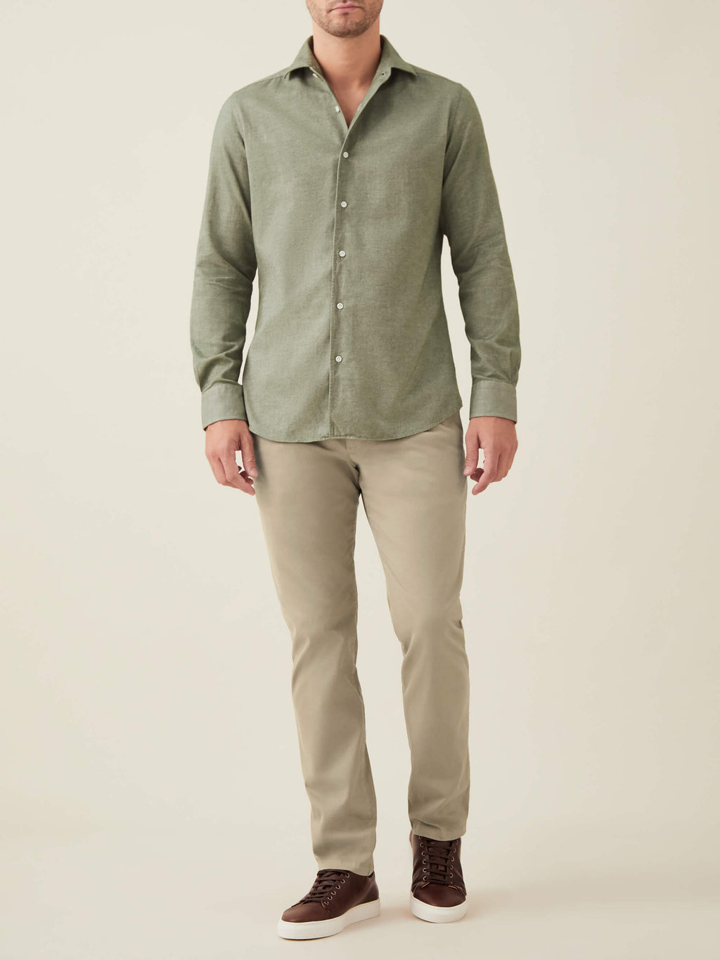 Full-length view of a model wearing the Luca Faloni Moss Green Brushed Cotton Shirt with beige chinos and brown trainers.