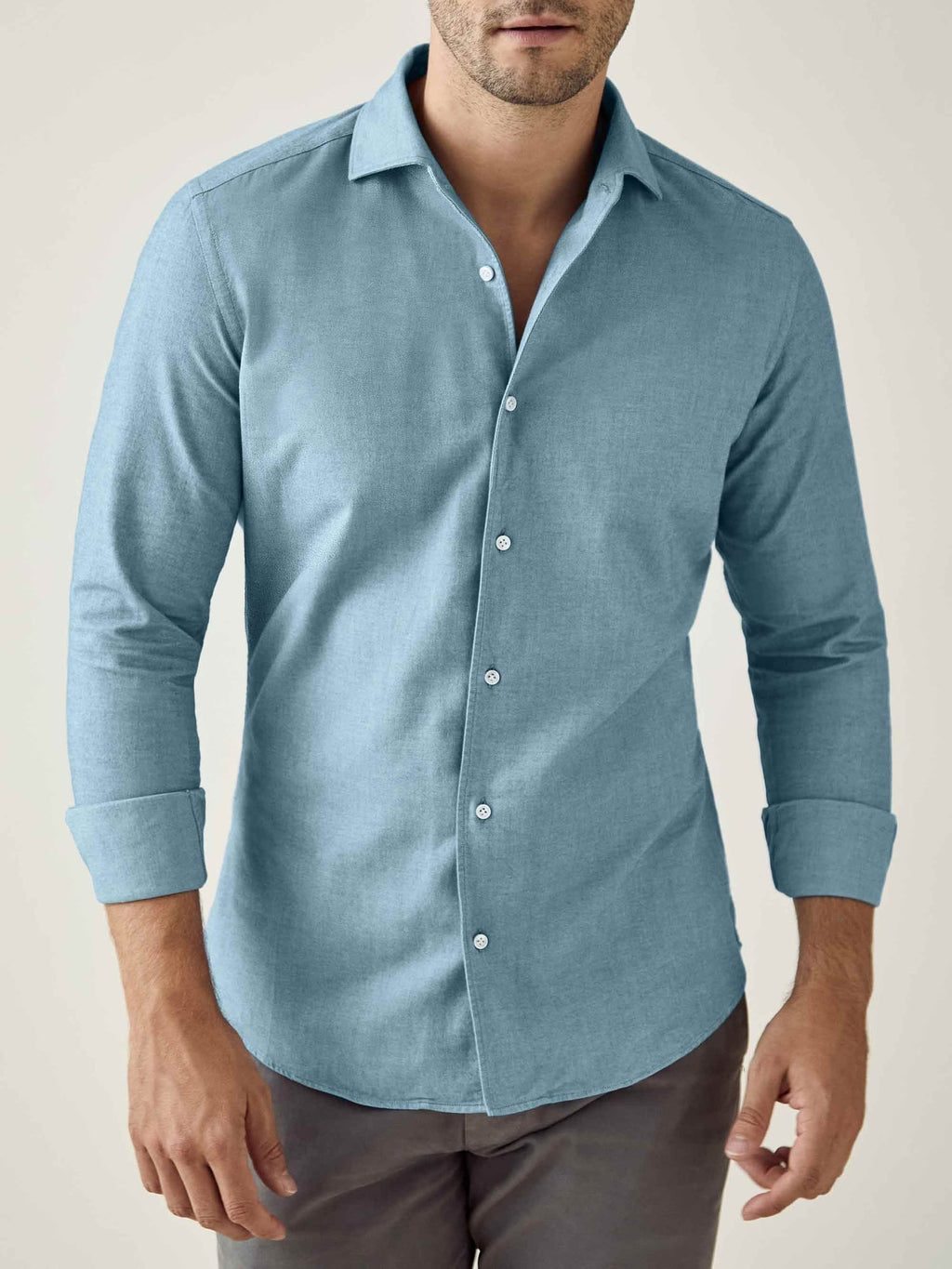 Model wears the Luca Faloni Brushed Cotton Shirt in Topaz. Front view with sleeves rolled up.