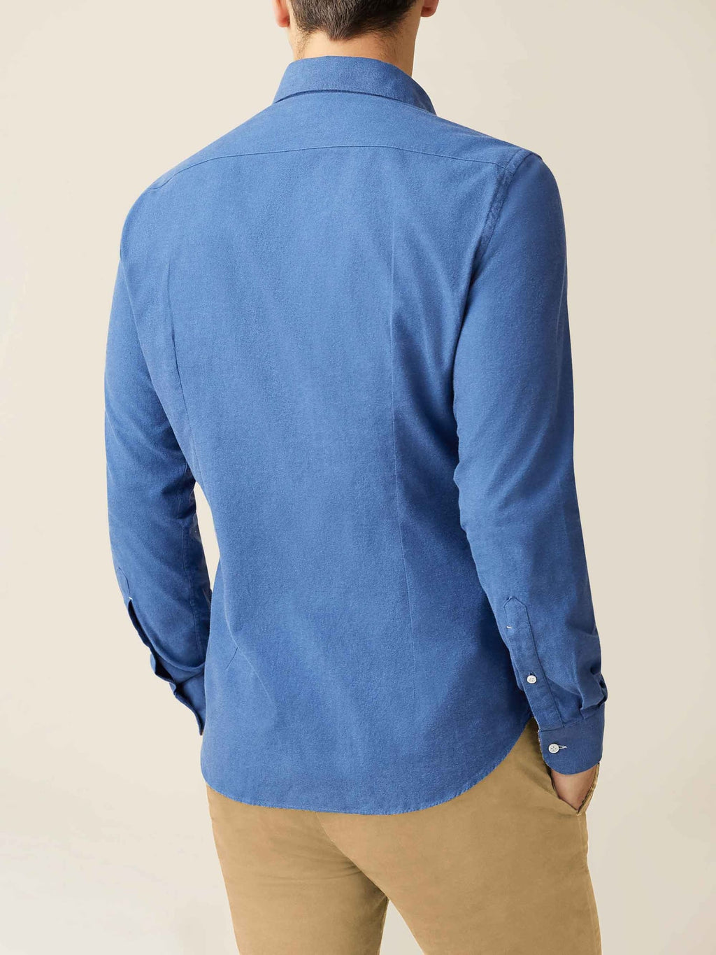 Back view of a model wearing the Luca Faloni Brushed Cotton Shirt in Chambray Blue with beige chinos.