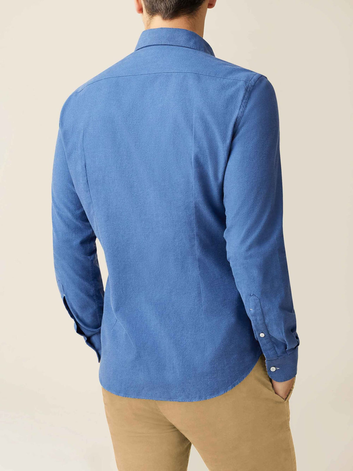 Back view of a model wearing the Luca Faloni Brushed Cotton Shirt in Chambray Blue with beige chinos.